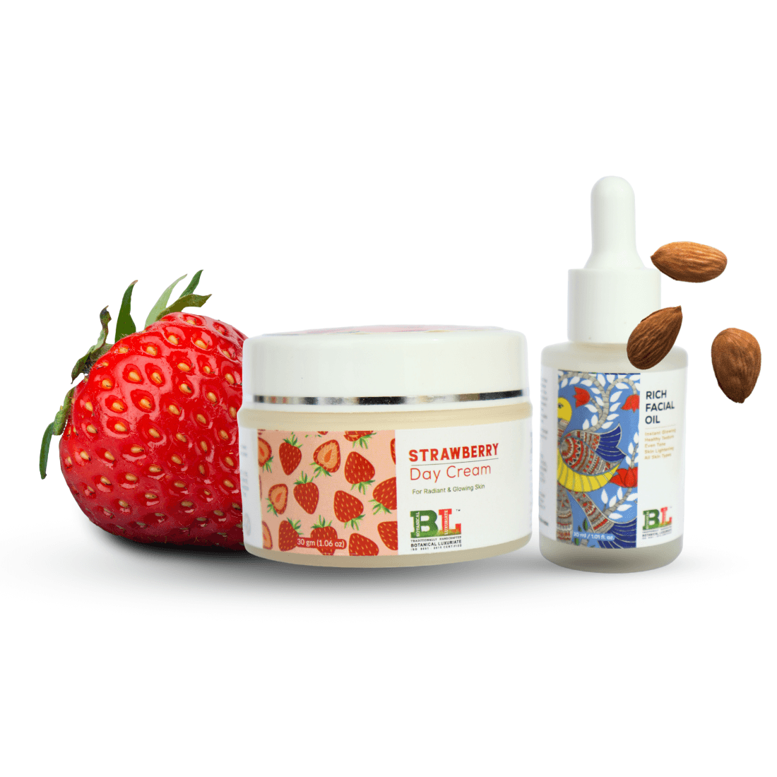 Strawberry day cream and rich facial oil combo by Botanical Luxuriate, surrounded by fresh strawberries and almonds for healthy glowing skin.